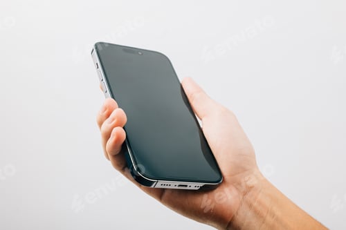 Preview: A hand holding a black cell phone isolated on white background, Man hand holding black smartphone