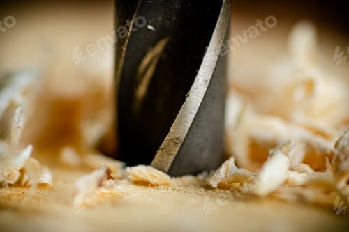 Preview: Piece of wood is drilled with shavings.
