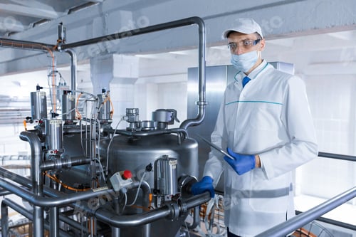 Preview: man in a white robe and a cap make an inspection of the production line