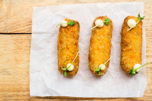 Preview: Fried Appetizers Garnished on a Wooden Table