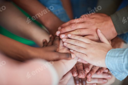Preview: Teamwork will get it done. High angle shot of university students hands in a huddle.
