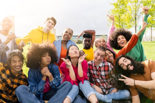 Preview: Diverse young people having fun outdoors laughing together making funny faces