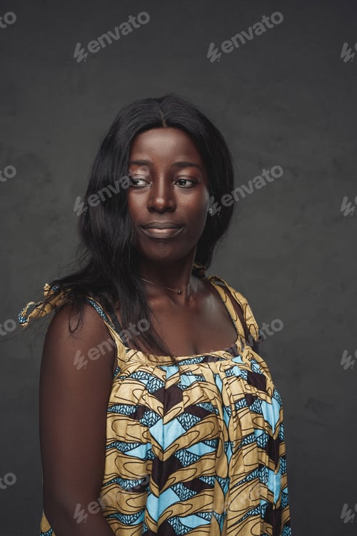 Preview: Black woman weared in dress against dark background