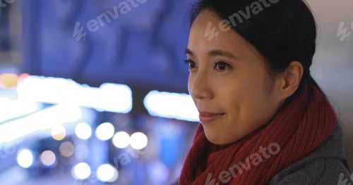 Preview: Woman look far away in city at night