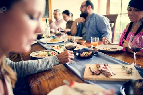 Preview: Group of diverse friends are having a dinner together