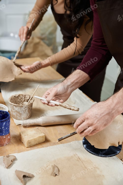 Preview: Loving couple creating pottery together in a modern studio during a cozy afternoon