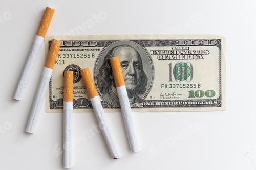 Preview: Pack of cigarettes on a photo of hundred-dollar notes. Concept of high cost of smoking