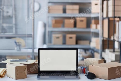 Preview: Laptop with blank screen standing on workplace of manager of storage room