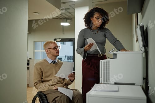 Preview: Middle Aged Caucasian Man with Disability Collaborating with Black Woman