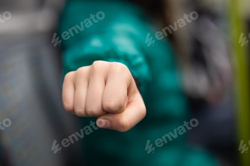 Preview: small hand child caucasian fist punch anger defence fight green jacket