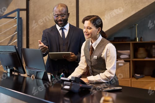 Preview: Discussing Work Details at Reception Desk