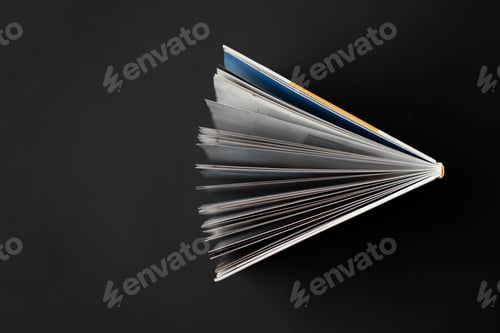 Preview: a directly above view of the opened book on black background, spreaded pages
