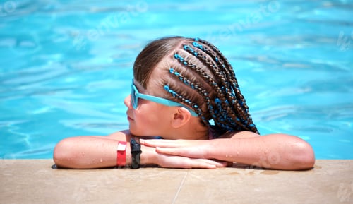 Preview: Portrait of happy child girl relaxing on swimming pool side on sunny summer day
