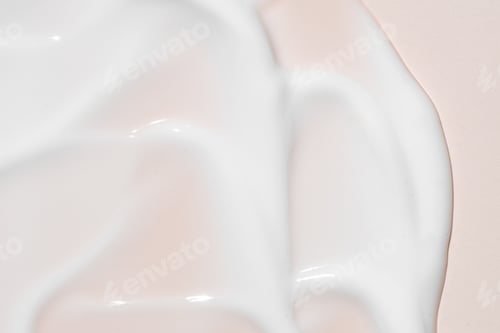 Preview: Texture of white cream on pink background. Smear of moisturizer close up. Lotion swatch. Beauty skin