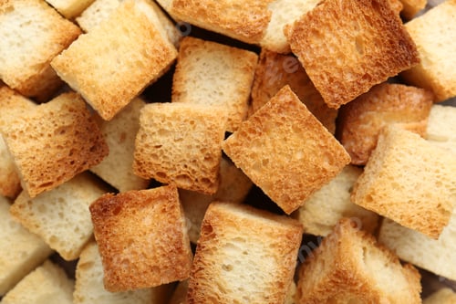 Preview: Tasty crispy croutons as background, top view