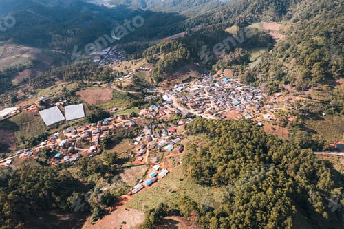 Preview: Aerial view of local rural village in the valley on faraway at countryside