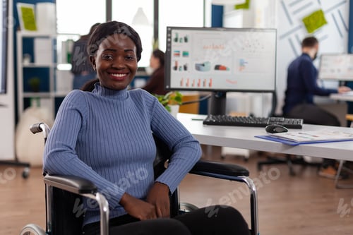 Preview: Portrait of smiling disabled paralyzed african american businesswoman in wheelchair