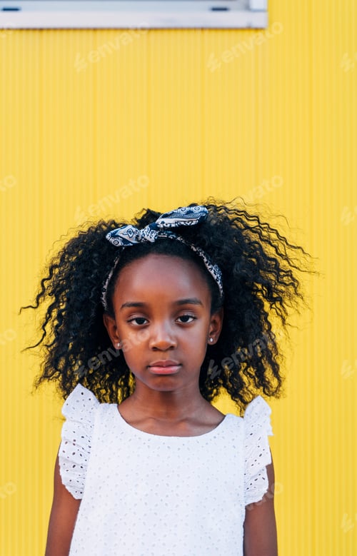 Preview: Cute mixed race girl having fun at street. Child innocence concept.