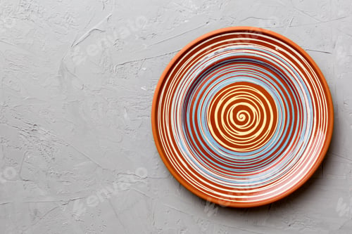 Preview: Top view of empty colorful plate on cement background. Empty space for your design