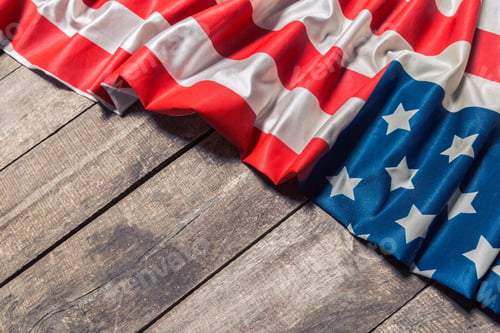 Preview: An American Flag Lying on an aged, weathered rustic wooden background