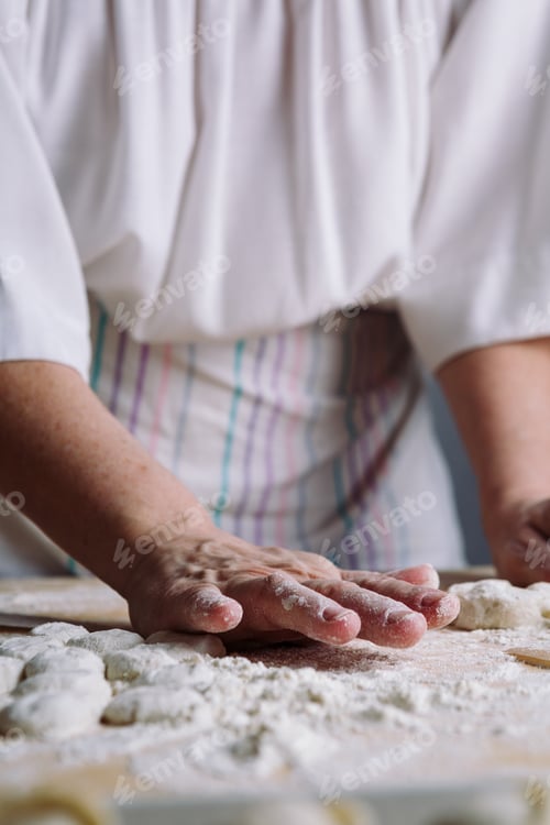 Preview: Two hands making dough for meat dumplings.