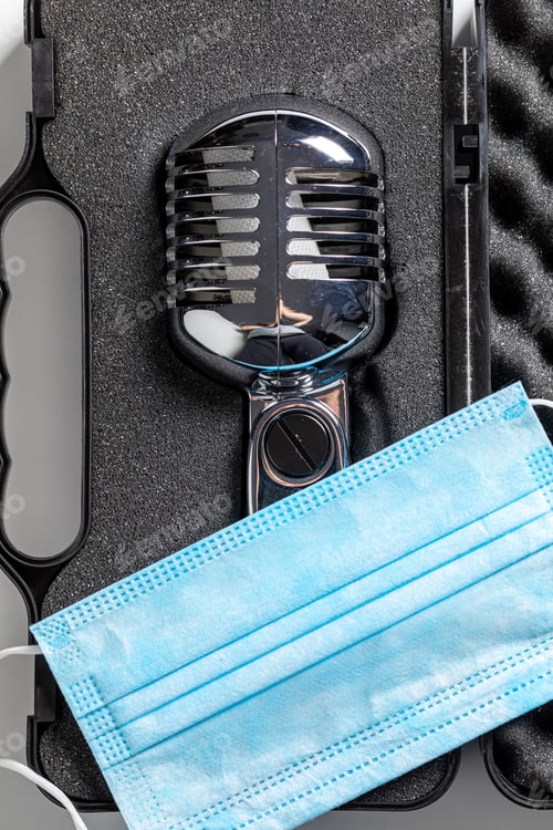 Preview: Music business and coronavirus restriction. Microphone and blue mask