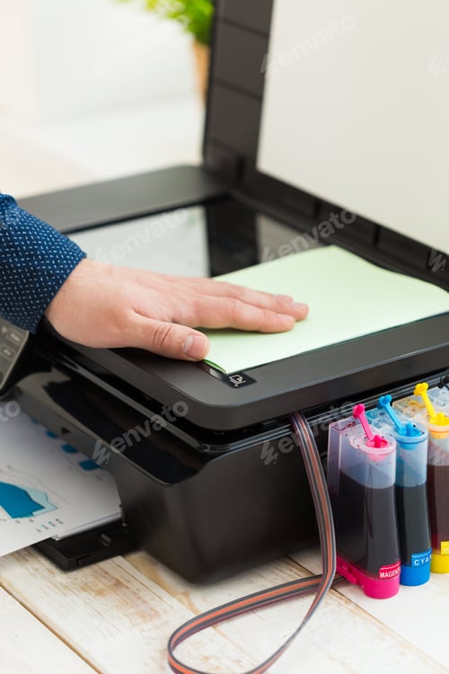 Preview: Man's hand making copies. Working with printer