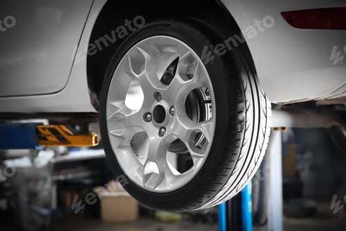 Preview: Car on lift at tire service, closeup