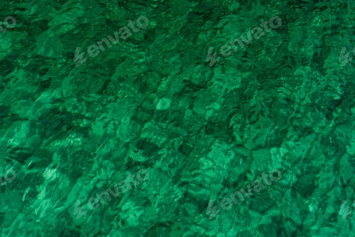 Preview: Green abstract texture background of emerald green sea water. Top view of green sea water