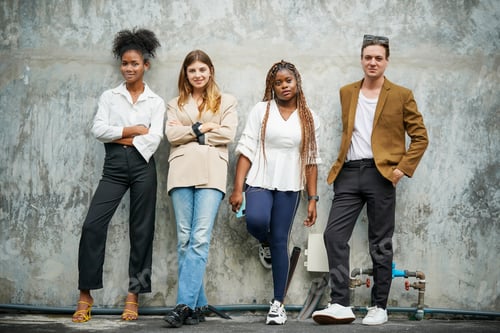 Preview: Young Adults Posing Together Against a Concrete Wall