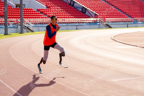 Preview: Asian para-athletes with prosthetic blades sprint on a running track at stadium.