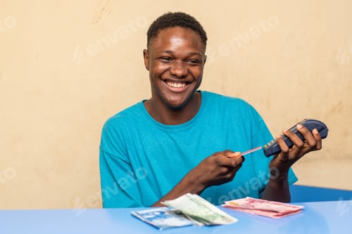 Preview: African male making a payment on a pos terminal