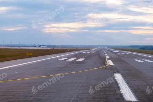 Preview: A long, straight runway stretches into the distance at the airport.