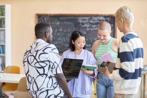 Preview: Group of intercultural students listening to explanations of classmate