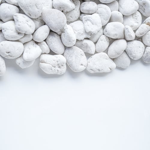 Preview: White pebble stones on white background with copy space.