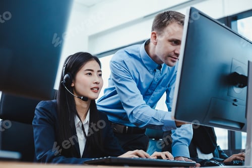 Preview: Assistant supervising the call center staff in the office.