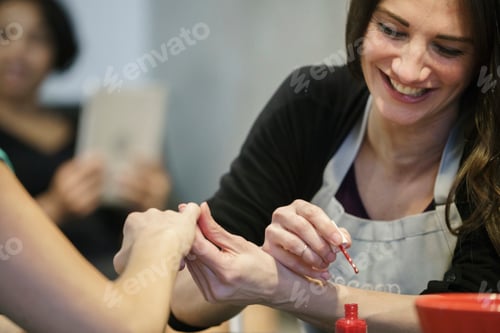 Preview: Woman Applying Red Nail Polish at Home
