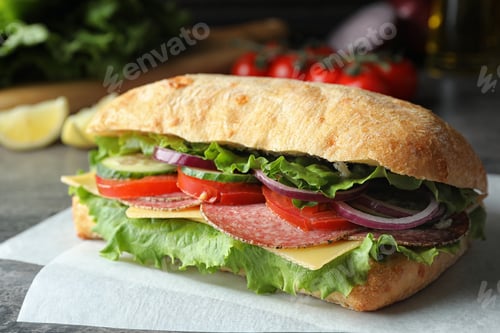 Preview: Delicious sandwich with fresh vegetables and salami on table