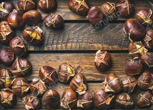 Preview: Close-up of roasted chestnuts over rustic wooden background