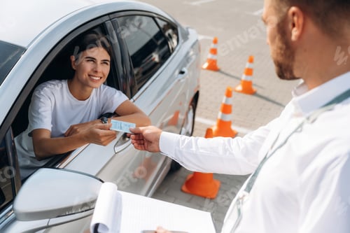 Preview: Congratulations giving the license, passed. Woman is trying to pass exam in the driving school