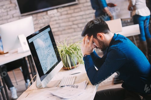 Preview: Pensive overworked architect working on corporate project