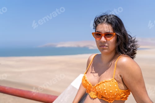 Preview: Young woman enjoying stunning ocean view on desert beach vacation