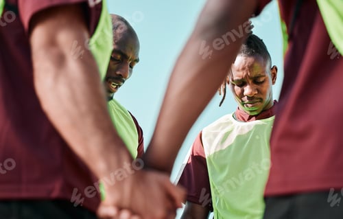 Preview: Sport, men and team holding hands for praying on field for training, workout and game motivation ou