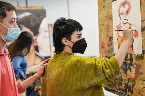 Preview: Multiethnic students painting together inside art classroom at university