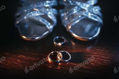 Preview: Close-up of two gold wedding rings in a black background.Wedding ring.Wedding rings