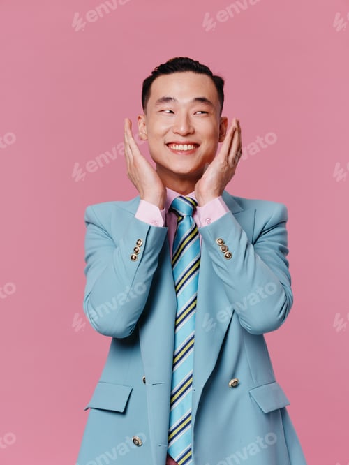 Preview: Cheerful man elegant style blue suit emotions pink background