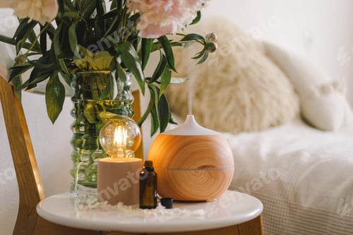 Preview: Aroma oil diffuser on chair against in the bedroom. Air freshener.