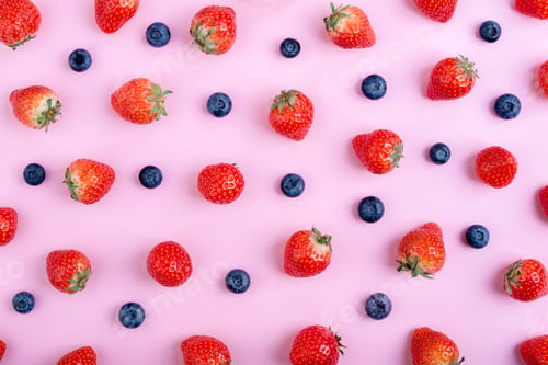 Preview: Strawberry and blueberry on pastel pink background, top view. Berries pattern, flat lay