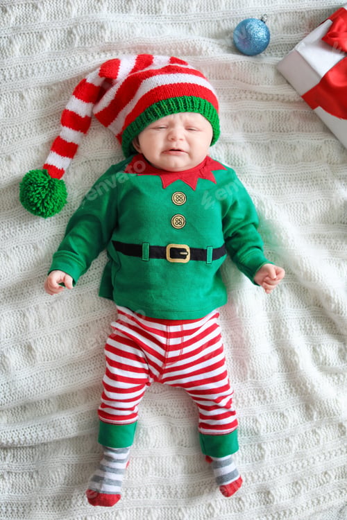 Preview: Cute baby in Christmas costume lying on blanket