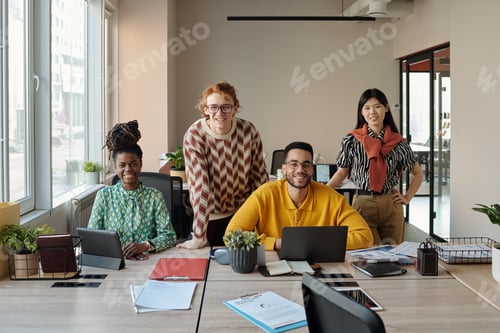 Preview: Smiling Young Adult Coworkers Collaborating in Creative Coworking Office Space